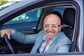 Handsome young business smiling man looking out of his new car window Royalty Free Stock Photo