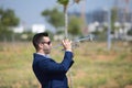 Handsome young businessman with a beard and a blue suit playing the trumpet. The man is a musician in his spare time and music is Royalty Free Stock Photo