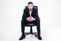 Handsome young businessman with beard sitting in black office chair Royalty Free Stock Photo