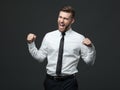 Handsome young businessman celebrating his success. Royalty Free Stock Photo