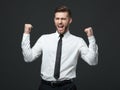 Handsome young businessman celebrating his success. Royalty Free Stock Photo