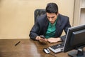 Handsome young businessman dialing on cell phone or typing text Royalty Free Stock Photo