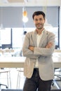 Handsome young businessman with folded arms in the office. Cheerful self confident man with crossed hands portrait. Business, Royalty Free Stock Photo