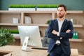 Handsome young businessman with folded arms in the office. Cheerful self confident man with crossed hands portrait Royalty Free Stock Photo