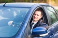 Handsome young businessman in his new car