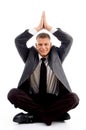 Handsome young businessman performing yoga
