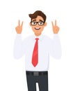 Handsome young businessman showing/gesturing two, victory or v sign with hand fingers. Smiling man making peace sign. Positive. Royalty Free Stock Photo