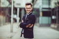 Young businessman smartly dressed while standing outdoors at the city street