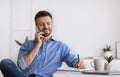 Handsome Businessman Talking On Cellphone And Taking Notes While Working In Office Royalty Free Stock Photo