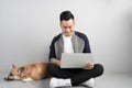 Handsome young businessman is using laptop while sitting with hi Royalty Free Stock Photo