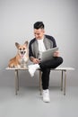 Handsome young businessman is using laptop while sitting with hi Royalty Free Stock Photo