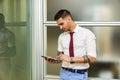 Handsome young businessman using tablet PC Royalty Free Stock Photo