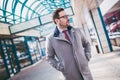 Handsome young businessman walking in front of building Royalty Free Stock Photo