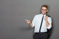A handsome young businessman wearing glasses and smiling. Vertic Royalty Free Stock Photo