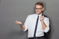 A handsome young businessman wearing glasses and smiling. Vertic Royalty Free Stock Photo