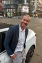 Handsome young caucasian businessman near car smiling Royalty Free Stock Photo