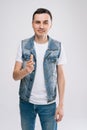 Handsome young Caucasian man in denim clothes pointing his finger at you Royalty Free Stock Photo