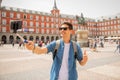Handsome young caucasian tourist man happy and excited taking a selfie in Plaza Mayor, Madrid Spain Royalty Free Stock Photo