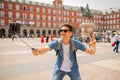 Handsome young caucasian tourist man happy and excited taking a selfie in Plaza Mayor, Madrid Spain Royalty Free Stock Photo