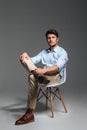 Handsome young confident man sitting on the chair Royalty Free Stock Photo