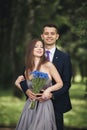 Handsome young couple posing outdoors after ceremony Royalty Free Stock Photo