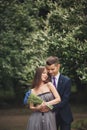 Handsome young couple posing outdoors after ceremony Royalty Free Stock Photo