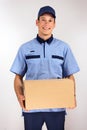 Handsome young delivery man carrying carton box Royalty Free Stock Photo