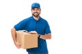 handsome young delivery man holding cardboard box and smiling at camera Royalty Free Stock Photo