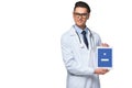 handsome young doctor holding tablet with facebook app on screen