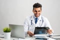 Handsome young doctor looking at x-ray scan Royalty Free Stock Photo
