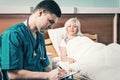 Handsome young doctor in uniform with phonendoscope on his neck Royalty Free Stock Photo