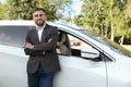 Handsome young driver near modern car on city street Royalty Free Stock Photo