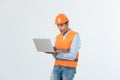 Handsome young engineer man over grey wearing safety helmet with shocked surprise face. Royalty Free Stock Photo