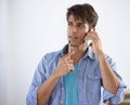 Think before you speak.... Handsome young ethnic man looking sideways thoughtfully while speaking on his cellphone. Royalty Free Stock Photo
