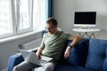 Handsome young European man with beard sitting on the sofa with laptop Royalty Free Stock Photo