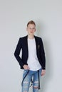 Handsome young fashion male model posing with jacket over his shoulder. Royalty Free Stock Photo