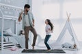 Handsome Young Father Dancing with Little Girl