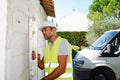 Handsome young foreman supervising a house renovation contruction site Royalty Free Stock Photo
