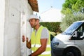 Handsome young foreman supervising a house renovation contruction site