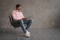 Handsome Young Freelancer Guy Using Laptop While Sitting In Arnchair At Home, Millennial Man Working Online On Computer Royalty Free Stock Photo