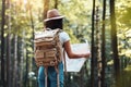 Handsome young girl traveling among trees in forest at sunset