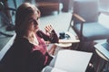 Handsome young girl wearing glasses casual clothes holding book hands.Woman blonde sitting in vintage armchair modern Royalty Free Stock Photo