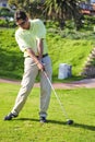 Handsome young golfer in action