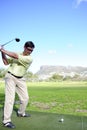 Handsome young golfer in action