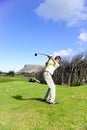 Handsome young golfer in action