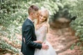 Handsome young groom kisses bride tenderly Royalty Free Stock Photo