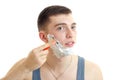 Handsome young guy shaves his beard machine using shaving foam on your face closeup Royalty Free Stock Photo