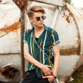 Handsome young guy with a stylish hairdo in a fashion beach Royalty Free Stock Photo