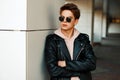 Handsome young guy with sunglasses in a fashionable branded Royalty Free Stock Photo