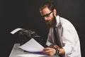 Handsome young hipster businessman thinking and writing with vintage typewriter. Royalty Free Stock Photo